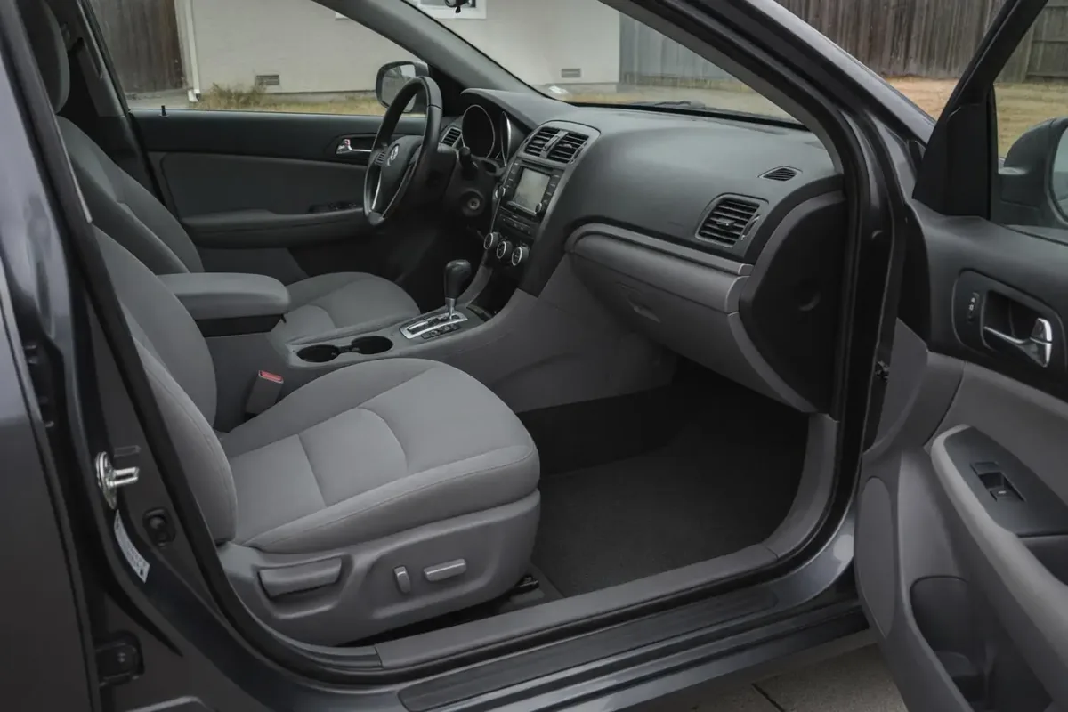 The same car interior after detailing, with vacuumed seats, wiped dash and a clear footwell
